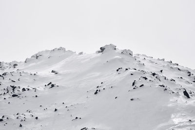 Scenic view of snow covered mountains against clear sky