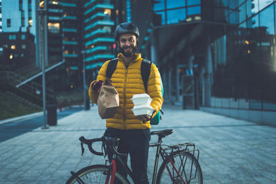 Portrait of man riding bicycle on city