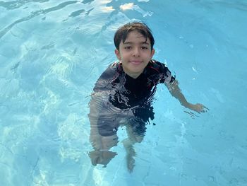 Portrait of boy swimming in pool