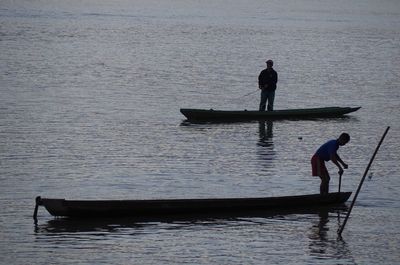 Men standing on boat in sea