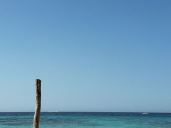 Scenic view of sea against clear blue sky