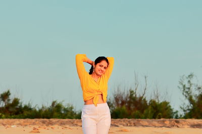 Woman standing against clear sky