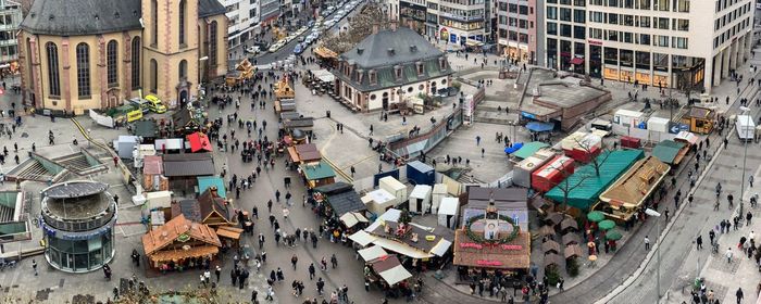 High angle view of people on street amidst buildings in city