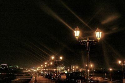 Illuminated city against sky at night