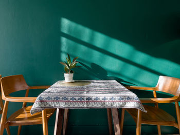 Empty chairs and table against wall at home