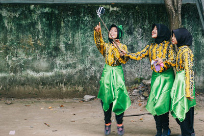 Full length of young women in traditional clothing