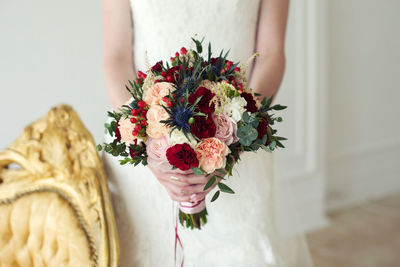 Midsection of woman holding bouquet