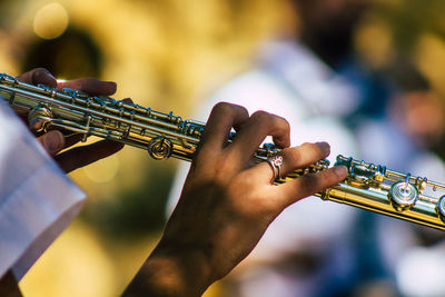 Close-up of man playing guitar at music concert