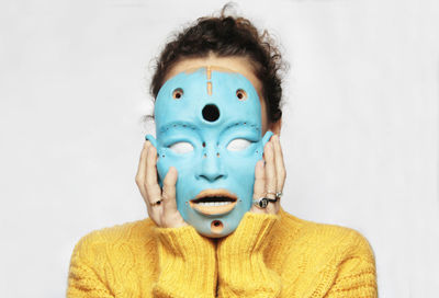 Close-up portrait of human face against white background