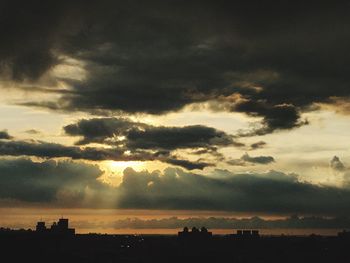 Silhouette of landscape against cloudy sky