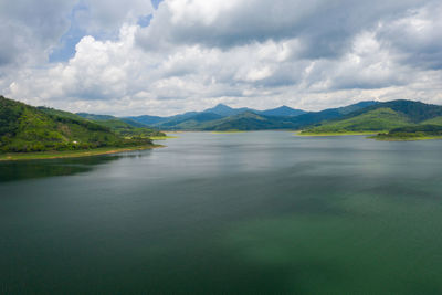 Scenic view of lake and mountains against sky