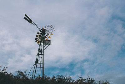 Low angle view of communications tower against sky