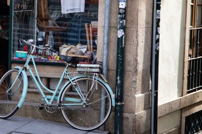 Bicycle parked on street by building