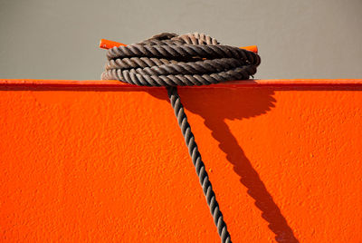 Close-up of rope tied on metal wall