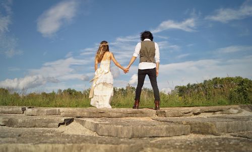 Low angle view of woman standing against sky