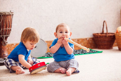 Cute siblings playing on floor