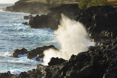 Waves breaking on rocks at shore