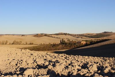 Scenic view of arid landscape against clear sky