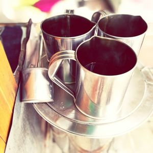 Close-up of black coffee in cups on plate