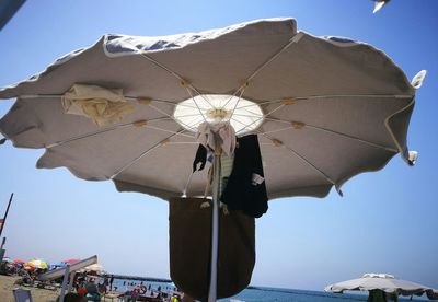 Low angle view of umbrella against clear sky