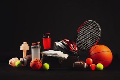 Close-up of tennis ball on table against black background
