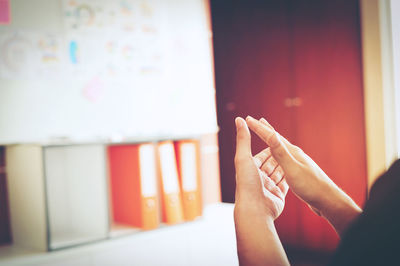 Close-up of person with hands clasped