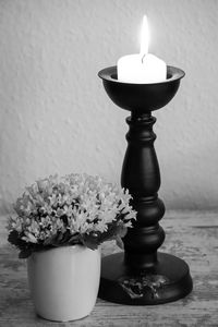 Close-up of flower vase on table against wall