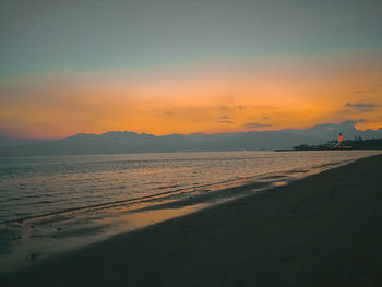 Scenic view of beach against sky during sunset