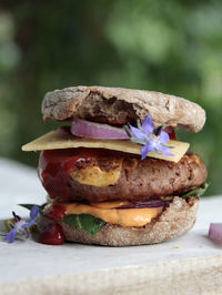 Close-up of vegan burger on stack of table