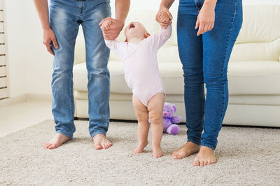 Parents playing with daughter at home