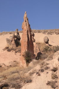 Rock formations in desert against clear blue sky