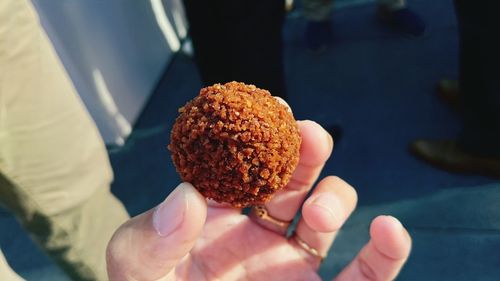Close-up of hand holding deep fried snack