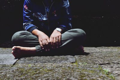 Low section of man sitting outdoors