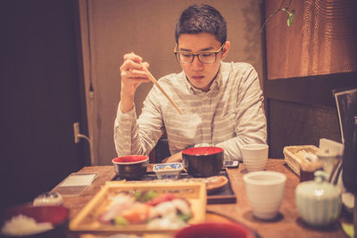 Man having meal while sitting in restaurant