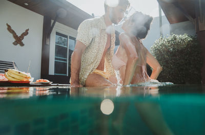 Reflection of statue on table in swimming pool