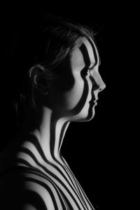 Portrait of a woman with projected lines of light