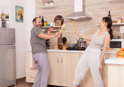 Woman holding ice cream at home