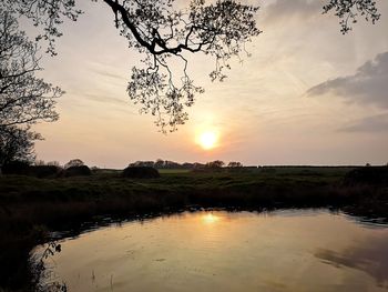 Scenic view of lake against sky during sunset