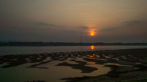 Scenic view of lake against sky during sunset