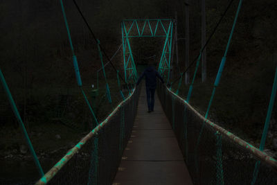 Rear view of woman on footbridge