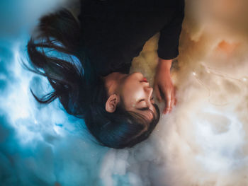 High angle view of man sleeping in bathroom