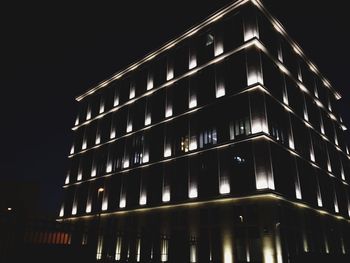 Low angle view of illuminated building at night