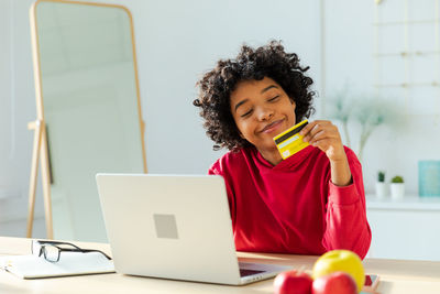 Young woman using laptop at table