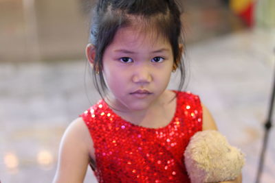 Portrait of cute girl standing at home