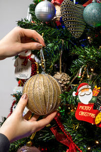 Close-up of woman holding christmas decoration