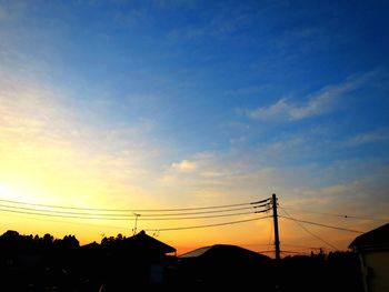 Silhouette buildings against sky during sunset