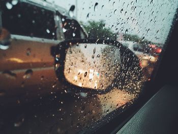 Close-up of wet car window in rainy season