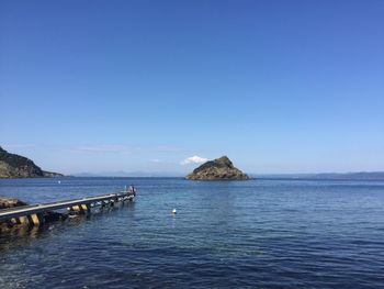 Scenic view of sea against clear blue sky