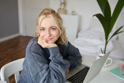 Young woman using laptop at home