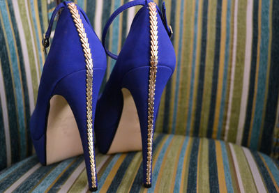 Close-up of blue high heels in chair